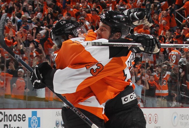 PHILADELPHIA - APRIL 18: Daniel Carcillo #13 (R) of the Philadelphia Flyers scores the game winning goal at 3:35 of overtime and is hugged by Simon Gagne #12 (L) as the Flyers defeat the New Jersey Devils 3-2 in Game Three of the Eastern Conference Quarterfinals during the 2010 NHL Stanley Cup Playoffs at the Wachovia Center on April 18, 2010 in Philadelphia, Pennsylvania. (Photo by Bruce Bennett/Getty Images)