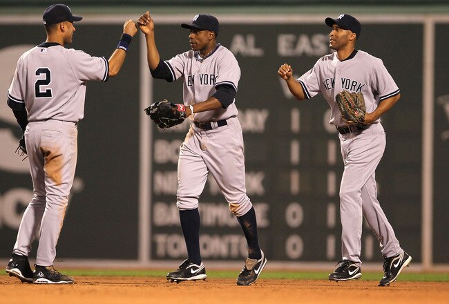 BOSTON - APRIL 07:  Curtis Granderson #14 of the New York Yankees celebrates with teammates Randy Winn #22 and Derek Jeter #2 after defeating the Boston Red Sox at Fenway Park on April 7, 2010 in Boston, Massachusetts. (Photo by Jim Rogash/Getty Images)