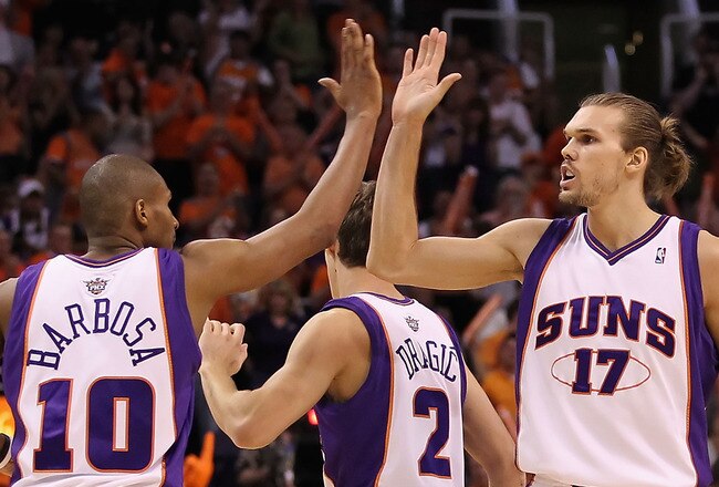 PHOENIX - APRIL 18:  Louis Amundson #17 of the Phoenix Suns high fives teammate Leandro Barbosa #10 after scoring against the Portland Trail Blazers during Game One of the Western Conference Quarterfinals of the 2010 NBA Playoffs at US Airways Center on April 18, 2010 in Phoenix, Arizona. NOTE TO USER: User expressly acknowledges and agrees that, by downloading and or using this photograph, User is consenting to the terms and conditions of the Getty Images License Agreement.  (Photo by Christian Petersen/Getty Images)