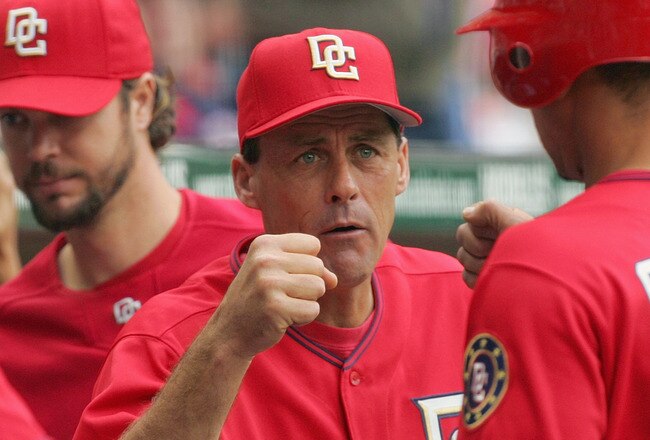 WASHINGTON - MAY 25:  Pitching coach Randy St. Claire of the Washington Nationals congratulates Royce Clayton #10 after Clayton scored a run against the Houston Astros on May 25, 2006 at RFK Stadium in Washington, DC. The Nationals defeated the Astros 8-5. (Photo by Jamie Squire/Getty Images)