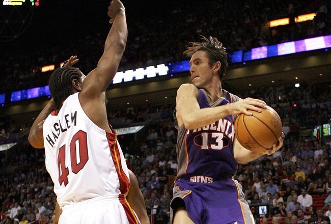 MIAMI - JANUARY 26:  Steve Nash #13 of the Phoenix Suns looks for a passing lane around Udonis Haslem #40 of the Miami Heat at American Airlines Arena on January 26, 2006 in Miami, Florida. NOTE TO USER:  User expressly acknowledges and agrees that, by downloading and or using this photograph, User is consenting to the terms and conditions of the Getty Images License Agreement.  (Photo by Doug Benc/Getty Images)