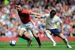 MANCHESTER, ENGLAND - APRIL 24:  Ryan Giggs of Manchester United competes for the ball with David Bentley of Tottenham Hotspur during the Barclays Premier League match between Manchester United and Tottenham Hotspur at Old Trafford on April 24, 2010 in Manchester, England.  (Photo by Michael Regan/Getty Images)