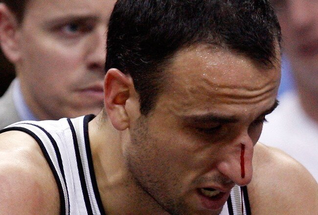 SAN ANTONIO - APRIL 23:  Guard Manu Ginobili #20 of the San Antonio Spurs is attended to after being hit in the nose against the Dallas Mavericks in Game Three of the Western Conference Quarterfinals during the 2010 NBA Playoffs at AT&T Center on April 23, 2010 in San Antonio, Texas. NOTE TO USER: User expressly acknowledges and agrees that, by downloading and or using this photograph, User is consenting to the terms and conditions of the Getty Images License Agreement.  (Photo by Ronald Martinez/Getty Images)