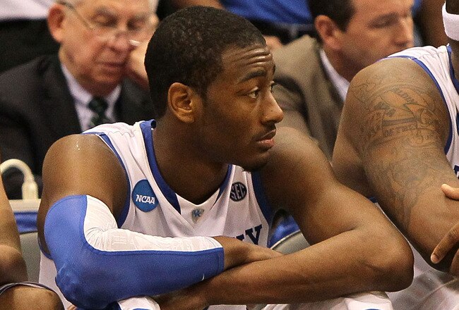 SYRACUSE, NY - MARCH 27:  (L-R) John Wall #11 and DeMarcus Cousins #15 of the Kentucky Wildcats sit on the bench dejected in the final minutes of the second half against the West Virginia Mountaineers during the east regional final of the 2010 NCAA men's basketball tournament at the Carrier Dome on March 27, 2010 in Syracuse, New York. West Virginia won 73-66. (Photo by Jim McIsaac/Getty Images)