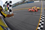 TALLADEGA, AL - APRIL 25:  Kevin Harvick, driver of the #29 Shell/Pennzoil Chevrolet, crosses the finish line ahead of Jamie McMurray, driver of the #1 Bass Pro Shops Chevrolet, to win the NASCAR Sprint Cup Series Aaron's 499 at Talladega Superspeedway on April 25, 2010 in Talladega, Alabama.  (Photo by Todd Warshaw/Getty Images)