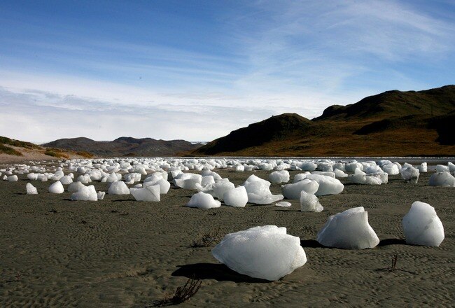 KANGERLUSSUAQ, GREENLAND - SEPTEMBER 01: (ISRAEL OUT) Ice boulders left behind after a flood caused by the overflowing of a lake, east to the town of Kangerlussuaq on September 01, 2007 Greenland. Scientists believe that Greenland, with its melting ice caps and disappearing glaciers, is an accurate thermometer of global warming. (Photo by Uriel Sinai/Getty Images)