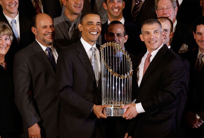 WASHINGTON - APRIL 26:  U.S. President Barack Obama and New York Yankees Manager Joe Girardi hold the Major League Baseball Commissioner's Trophy while posing for photographs with the World Series champs in the East Room of the White House April 26, 2010 in Washington, DC. Despite being a Chicago White Sox fan, Obama celebrated the Yankees' victory and pointed to the team's visit to Walter Reed Army Medical Center as an example of good community service.  (Photo by Chip Somodevilla/Getty Images)