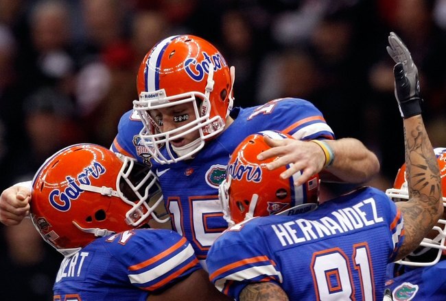NEW ORLEANS - JANUARY 01:  Tim Tebow #15 of the Florida Gators hugs his teammates Marcus Gilbert #76 and Aaron Hernandez #81 after scoring a touchdown against the Cincinnati Bearcats during the Allstate Sugar Bowl at the Louisana Superdome on January 1, 2010 in New Orleans, Louisiana.  (Photo by Kevin C. Cox/Getty Images)