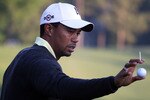 CHARLOTTE, NC - APRIL 28:  Tiger Woods reaches for a golf ball on the practice ground during the pro am prior to the start of the 2010 Quail Hollow Championship at the Quail Hollow Club on April 28, 2010 in Charlotte, North Carolina.  (Photo by Scott Halleran/Getty Images)