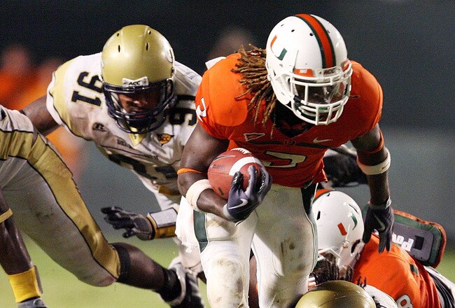 FORT LAUDERDALE, FL - SEPTEMBER 17:  Running back Graig Cooper #2 of the Miami Hurricanes breaks tackles against the Georgia Tech Yellow Jackets at Land Shark Stadium on September 17, 2009 in Fort Lauderdale, Florida. Miami defeated Georgia Tech 33-17.  (Photo by Doug Benc/Getty Images)