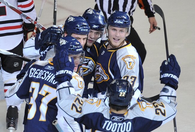 NASHVILLE, TN - APRIL 26:  Jordin Tootoo #22 , Denis Grebeshkov #37, and Colin Wilson #33 of the Nashville Predators celebrate with teammates after scoring a goal against the Chicago Blackhawks in Game Six of the Western Conference Quarterfinals during the 2010 NHL Stanley Cup Playoffs at Bridgestone Arena on April 26, 2010 in Nashville, Tennessee.  (Photo by Frederick Breedon/Getty Images)