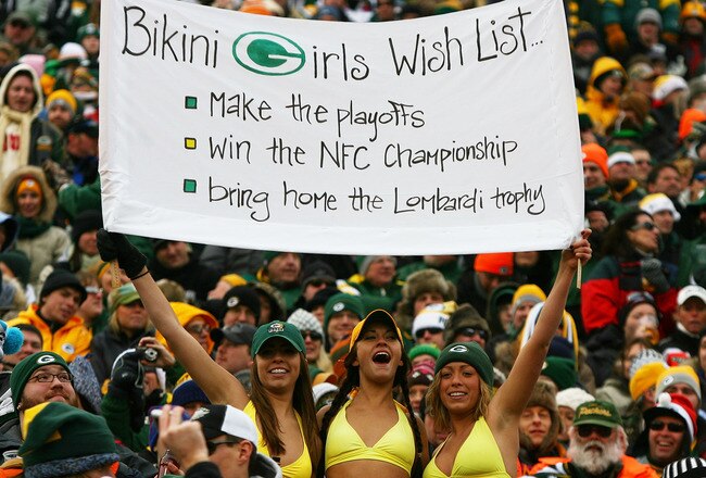 GREEN BAY, WI - DECEMBER 27: Fans of the Green Bay Packers hold a sign and wear bikini's in below freezing weather during a game between the Packers and the Seattle Seahawks at Lambeau Field on December 27, 2009 in Green Bay, Wisconsin. The Packers defeated the Seahawks 48-10. (Photo by Jonathan Daniel/Getty Images)