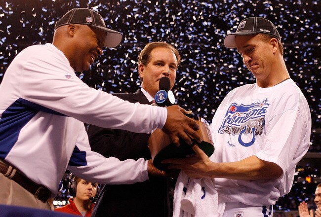 INDIANAPOLIS - JANUARY 24:  Head coach Jim Caldwell hands quarterback Peyton Manning #18 of the Indianapolis Colts the Lamar Hunt trophy after the Colts defeated the New York Jets 30-17 to win the AFC Championship Game at Lucas Oil Stadium on January 24, 2010 in Indianapolis, Indiana.  (Photo by Elsa/Getty Images)