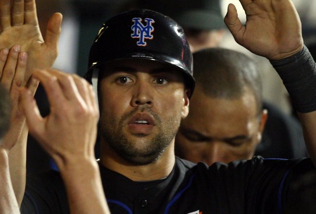 NEW YORK - JUNE 19:  Carlos Beltran #15 of the New York Mets celebrates in the dugout after scoring in the eigth inning against the Tampa Bay Rays on June 19, 2009 at Citi Field in the Flushing neighborhood of the Queens borough of New York City.  (Photo by Jim McIsaac/Getty Images)