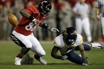 CINCINNATI - NOVEMBER 13:  Adrien Robinson #88 of the Cincinnati Bearcats is hit by Keith Tandy #8 of the West Virginia Mountaineers and fumbles the ball in the first quarter of the game at Nippert Stadium on November 13, 2009 in Cincinnati, Ohio.  (Photo by Andy Lyons/Getty Images)