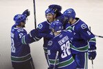 VANCOUVER, CANADA - APRIL 23:  Mikael Samuelsson #26 of the Vancouver Canucks is congratulated by teammates Henrik Sedin #33, Pavol Demitra #38 and Sami Salo #6 after scoring against the Los Angeles Kings during the third period in Game Five of the Western Conference Quarterfinals during the 2010 NHL Stanley Cup Playoffs on April 23, 2010 at General Motors Place in Vancouver, British Columbia, Canada.  (Photo by Rich Lam/Getty Images)