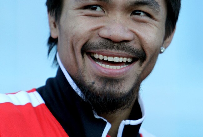 ARLINGTON, TX - MARCH 12:  Manny Pacquiao of the Philippines smiles after he steps on the scale during the weigh-in for his WBO welterweight title fight against Joshua Clottey of Ghana outside Cowboys Stadium on March 12, 2010 in Arlington, Texas. Pacquiao and Clottey will fight March 13, 2010 in Cowboys Stadium.  (Photo by Jed Jacobsohn/Getty Images)