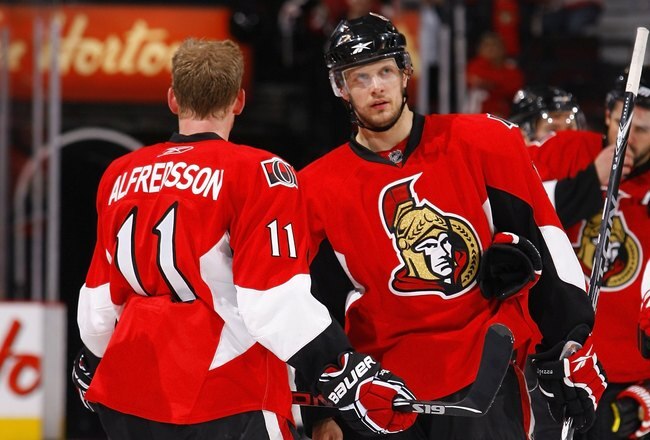 OTTAWA, ON - APRIL 24:  Jason Spezza #19 and Daniel Alfredsson #11 of the Ottawa Senators talk during a break in action against the Pittsburgh Penguins in Game 6 of the Eastern Conference Quaterfinals of the 2010 Stanley Cup Playoffs at Scotiabank Place on April 24, 2010 in Ottawa, Canada.  (Photo by Phillip MacCallum/Getty Images)