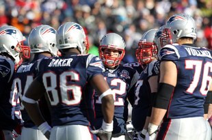 FOXBORO, MA - JANUARY 10:  Tom Brady #12 of the New England Patriots looks on from the huddle against the Baltimore Ravens during the 2010 AFC wild-card playoff game at Gillette Stadium on January 10, 2010 in Foxboro, Massachusetts. Ravens won 33-14. (Photo by Jim Rogash/Getty Images)
