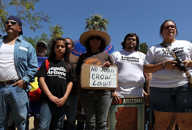 PHOENIX - APRIL 25:  Opponents of Arizona's new immigration enforcement law protest outside the state capitol building on April 25, 2010 in Phoenix, Arizona. More than 1,000 gathered to protest the passage of Arizona's tough new law which was signed by the state's Republican governor Jan Brewer two days before. Critics of the law say that it will encourage racial profiling by law enforcement and endanger civil rights in the state.  (Photo by John Moore/Getty Images)