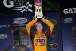 RICHMOND, VA - MAY 01:  Kyle Busch, driver of the #18 M&M's Toyota, celebrates with the trophy in victory lane after winning the NASCAR Sprint Cup Series Crown Royal Presents the Heath Calhoun 400 at Richmond International Raceway on May 1, 2010, 2010 in Richmond, Virginia.  (Photo by Chris Trotman/Getty Images)