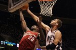 EAST RUTHERFORD, NJ - MARCH 03:  LeBron James #23 of the Cleveland Cavaliers lays up a shot against Brook Lopez #23 of the New Jersey Nets for a basket at the Izod Center on March 3, 2010 in East Rutherford, New Jersey.NOTE TO USER: User expressly acknowledges and agrees that, by downloading and or using this photograph, User is consenting to the terms and conditions of the Getty Images License Agreement.  (Photo by Jim McIsaac/Getty Images)