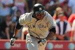 ANAHEIM, CA - APRIL 25: Curtis Granderson #14 of the New York Yankees runs to first after hitting a ground ball against the Los Angeles Angels Of Anaheim on April 25, 2010 in Anaheim, California.  (Photo by Jacob de Golish/Getty Images)