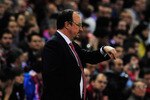 MADRID, SPAIN - APRIL 22:  Rafael Benitez manager of Liverpool checks his watch during the UEFA Europa League Semi Final first leg match between Atletico Madrid and Liverpool at the Vicente Calderon Stadium on April 22, 2010 in Madrid, Spain.  (Photo by Jamie McDonald/Getty Images)