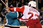 SAN JOSE, CA - APRIL 29:  Torrey Mitchell #17 of the San Jose Sharks gets hit by Brad Stuart #23 of the Detroit Red Wings in Game One of the Western Conference Semifinals during the 2010 NHL Stanley Cup Playoffs at HP Pavilion on April 29, 2010 in San Jose, California.  (Photo by Ezra Shaw/Getty Images)