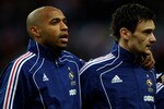 PARIS -FRANCE- MARCH 03: Thierry Henry (l) and Hugo Lloris (r) of France line up during the national anthems ahead of the France v Spain International Friendly match at the Stade de France on March 3, 2010 in Paris, France.  (Photo by Michael Steele/Getty Images)