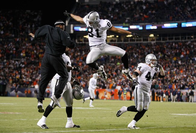 DENVER - DECEMBER 20:  Chaz Schilens #81 of the Oakland Raiders is congratulated by Javon Walker (L) after scoring a touchdown late in the fourth quarter against the Denver Broncos at Invesco Field at Mile High on December 20, 2009 in Denver, Colorado. The Raiders defeated the Broncos 20-19. (Photo by Jeff Gross/Getty Images)