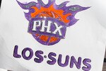 PHOENIX - MAY 05:  Phoenix Suns fan Isiah Quinonz poses with a 'Los Suns' sign before Game Two of the Western Conference Semifinals of the 2010 NBA Playoffs against the San Antonio Spurs at US Airways Center on May 5, 2010 in Phoenix, Arizona. The team is wearing 'Los Suns' jerseys on Cinco de Mayo in response to an anti-immigration law recently passed in Arizona.  NOTE TO USER: User expressly acknowledges and agrees that, by downloading and or using this photograph, User is consenting to the terms and conditions of the Getty Images License Agreement.  (Photo by Christian Petersen/Getty Images)