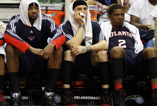 ORLANDO, FL - MAY 04:  (L to R) Josh Smith #5, Mike Bibby #10 and Joe Johnson #2 of the Atlanta Hawks sit on the bench and watch the fourth quarter against the Orlando Magic in Game One of the Eastern Conference Semifinals during the 2010 NBA Playoffs at Amway Arena on May 4, 2010 in Orlando, Florida. The Magic defeated the Hawks 114-71. NOTE TO USER: User expressly acknowledges and agrees that, by downloading and/or using this Photograph, user is consenting to the terms and conditions of the Getty Images License Agreement.  (Photo by Doug Benc/Getty Images)