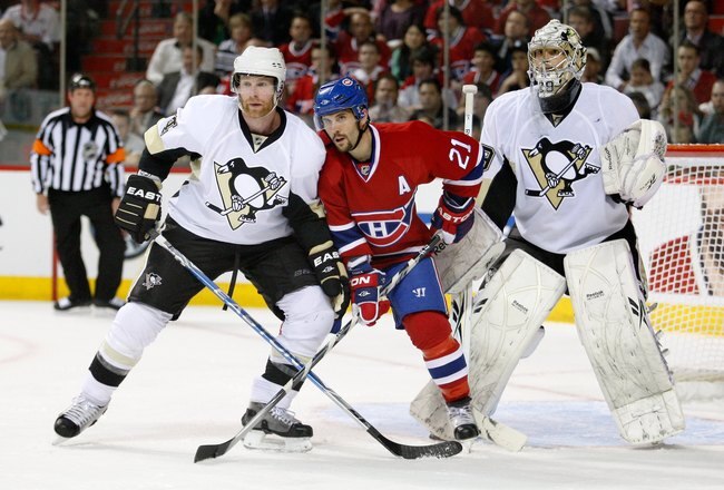 MONTREAL- MAY 6:  Brian Gionta #21 of the Montreal Canadiens battles for position in front of Jordan Leopold #4 and Marc-Andre Fleury #29 of the Pittsburgh Penguins in Game Four of the Eastern Conference Semifinals during the 2010 NHL Stanley Cup Playoffs at the Bell Centre on May 6, 2010 in Montreal, Quebec, Canada.  The Canadiens defeated the Penguins 3-2 tying the series 2-2.  (Photo by Richard Wolowicz/Getty Images)