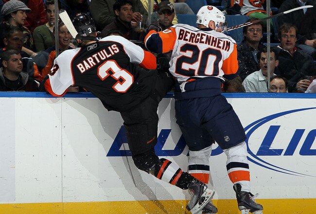 UNIONDALE, NY - APRIL 01:  Sean Bergenheim #20 of the New York Islanders lays a hit against Oskars Bartulis #3 of the Philadelphia Flyers on April 1, 2010 at Nassau Coliseum in Uniondale, New York.  (Photo by Jim McIsaac/Getty Images)