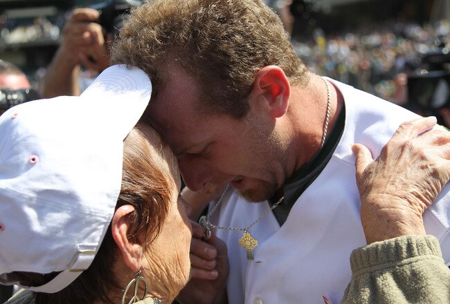 OAKLAND, CA - MAY 09:  Dallas Braden #51 of the Oakland Athletics celebrates after pitching a perfect game against the Tampa Bay Rays with his grandmother Peggy Lindsey during an MLB game at the Oakland-Alameda County Coliseum on May 9, 2010 in Oakland, California. Braden is seen kissing his mother's wedding ring who passed away.  (Photo by Jed Jacobsohn/Getty Images)