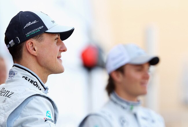 SAKIR, BAHRAIN - MARCH 14:  Michael Schumacher (L) of Germany and Mercedes GP and Nico Rosberg (R) of Germany and Mercedes GP appear at a team photocall in the pit lane before the Bahrain Formula One Grand Prix at the Bahrain International Circuit on March 14, 2010 in Sakir, Bahrain.  (Photo by Mark Thompson/Getty Images)