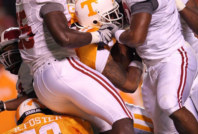 KNOXVILLE, TN - OCTOBER 25: Arian Foster #27 of the Tennessee Volunteers is tackled by Rolando McClain #25 and Dont'a Hightower #30 of the Alabama Crimson Tide during the game at Neyland Stadium on October 25, 2008 in Knoxville, Tennessee.  (Photo by Andy Lyons/Getty Images)