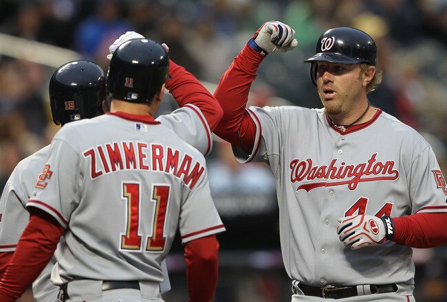 NEW YORK - MAY 11: Adam Dunn #44 of the Washington Nationals celebrates his three RBI homerun with scoring teammates Ryan Zimmerman #11 and Cristian Guzman #15 against the New York Mets at Citi Field on May 11, 2010 in the Flushing neighborhood of the Queens borough of New York City.  (Photo by Nick Laham/Getty Images)