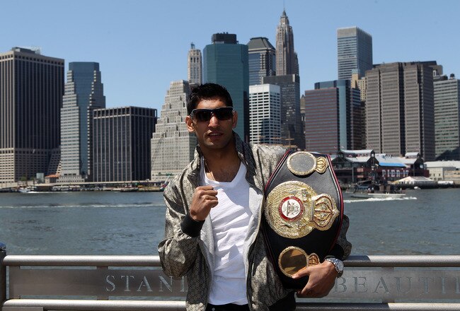 NEW YORK - MAY 10:  British boxer Amir Khan poses with the WBA World light welterweight championship belt by the Brooklyn Bridge on May 10, 2010 in the Brooklyn borough of New York City.  (Photo by John Gichigi/Getty Images)