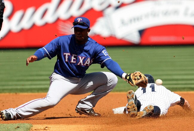 NEW YORK - APRIL 18:  Brett Gardner #11 of the New York Yankees avoids being tagged at second base by Andres Blanco #3 of the Texas Rangers on April 18, 2010 at Yankee Stadium in the Bronx borough of New York City. The Yankees defeated the Rangers 5-2.  (Photo by Chris Trotman/Getty Images)