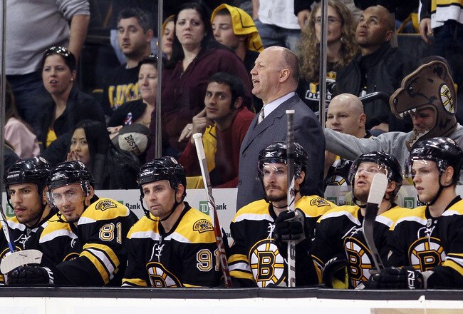 BOSTON - MAY 10:  Head coach Claude Julien of the Boston Bruins reacts to a penalty against Marc Savard #91 in the third period against the Philadelphia Flyers in Game Five of the Eastern Conference Semifinals during the 2010 NHL Stanley Cup Playoffs at TD Garden on May 10, 2010 in Boston, Massachusetts. The Flyers defeated the Bruins 4-0.  (Photo by Elsa/Getty Images)