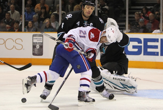 SAN JOSE, CA - MARCH 04:  Brian Gionta #21 of the Montreal Canadiens is defended by Rob Blake #4 of the San Jose Sharks during an NHL game at the HP Pavilion  on March 4, 2010 in San Jose, California.  (Photo by Jed Jacobsohn/Getty Images)