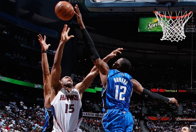 ATLANTA - MAY 10:  Dwight Howard #12 of the Orlando Magic blocks a shot by Al Horford #15 of the Atlanta Hawks during Game Four of the Eastern Conference Semifinals of the 2010 NBA Playoffs at Philips Arena on May 10, 2010 in Atlanta, Georgia.  NOTE TO USER: User expressly acknowledges and agrees that, by downloading and/or using this Photograph, User is consenting to the terms and conditions of the Getty Images License Agreement.  (Photo by Kevin C. Cox/Getty Images)