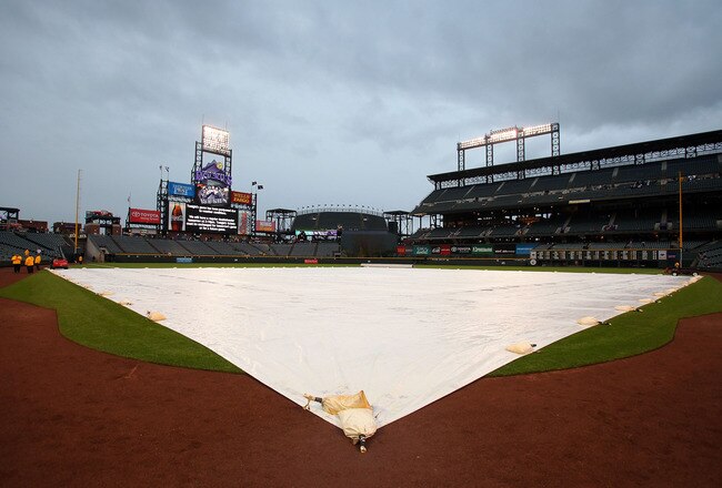 DENVER - APRIL 23:  The tarp covers the infield as rain falls postponing the game between the Florida Marlins and the Colorado Rockies at Coors Field on April 23, 2010 in Denver, Colorado. The game was rescheduled as the first game of a double header on April 24, 2010.  (Photo by Doug Pensinger/Getty Images)