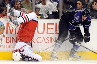 LOS ANGELES, CA - OCTOBER 25:  Rob Scuderi #7 of the Los Angeles Kings knocks Jason Chimera #25 of the Columbus Blue Jackets to the ice with a bodycheck during the first period at the Staples Center on October 25, 2009 in Los Angeles, California.  (Photo by Harry How/Getty Images)