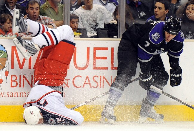 LOS ANGELES, CA - OCTOBER 25:  Rob Scuderi #7 of the Los Angeles Kings knocks Jason Chimera #25 of the Columbus Blue Jackets to the ice with a bodycheck during the first period at the Staples Center on October 25, 2009 in Los Angeles, California.  (Photo by Harry How/Getty Images)