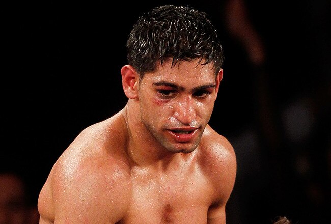 NEW YORK - MAY 15:  Amir Khan (L) of Great Britain celebrates with a trainer after defeating Paulie Malignaggi by TKO in the 11th round of his WBA light welterweight title fight at Madison Square Garden on May 15, 2010 in New York City.  (Photo by Chris Trotman/Getty Images)