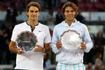 MADRID, SPAIN - MAY 16:  Mens finalist Rafael Nadal and  Roger Federer of Switzerland hold aloft their trophies after the mens final match during the Mutua Madrilena Madrid Open tennis tournament at the Caja Magica on May 16, 2010 in Madrid, Spain.  (Photo by Clive Brunskill/Getty Images)