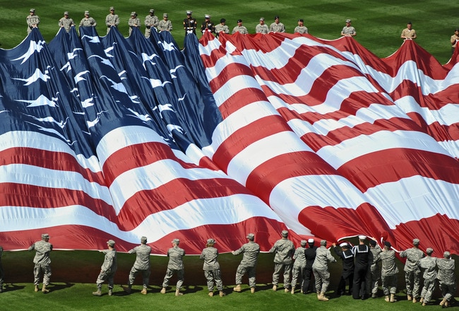 PHILADELPHIA - APRIL 12: Members of the United States military bring out the American Flag before the game between the Washington Nationals and Philadelphia Phillies on Opening Day at Citizens Bank Park on April 12, 2010 in Philadelphia, Pennsylvania. (Photo by Drew Hallowell/Getty Images)